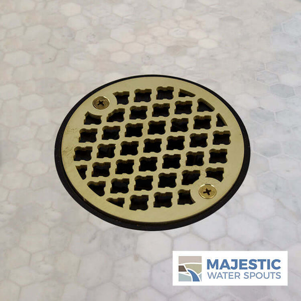 http://majesticwaterspouts.com/cdn/shop/products/Designer_Brushed_Brass_Shower_Drain_Cover_Strainer_On_Marble_Monet_Small_Logo_grande.jpg?v=1643294136