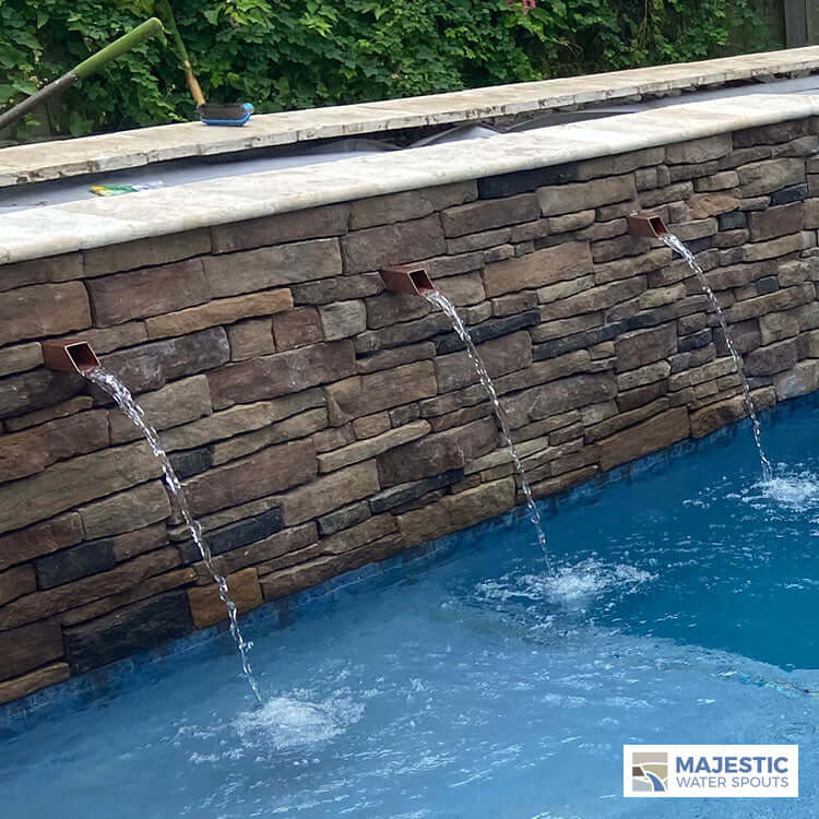 Copper Square Water Spouts in Pool Wall