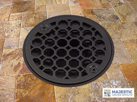 Bronze decorative shower drain cover installed in shower tiled