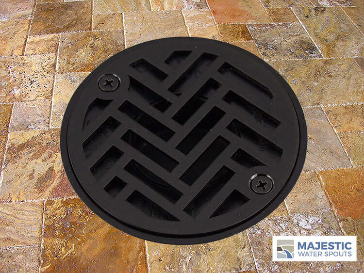 https://majesticwaterspouts.com/cdn/shop/products/4_In_Round_Custom_Shower_Drain_Cover_Strainer_Bronze_On_Travertine_Louis_Small_logo_1024x1024.jpg?v=1643293967