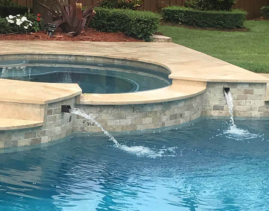 Rust color square water spout in pool and spa