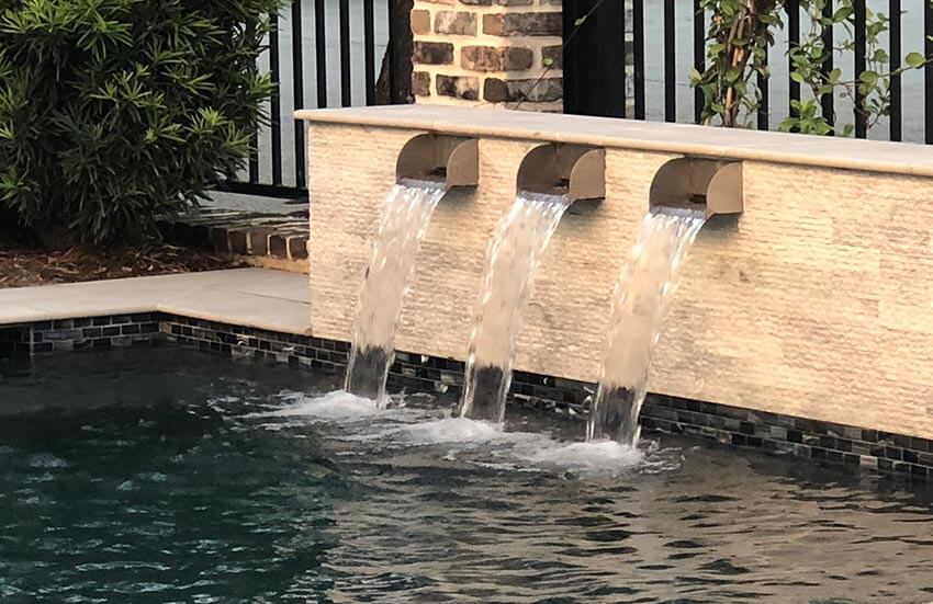 Stainless Steel Scuppers by Majestic Water Spouts in Pool with Limestone